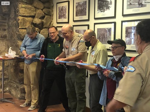 The ribbon is cut for the Ten Mile River Scout Museum photo show.